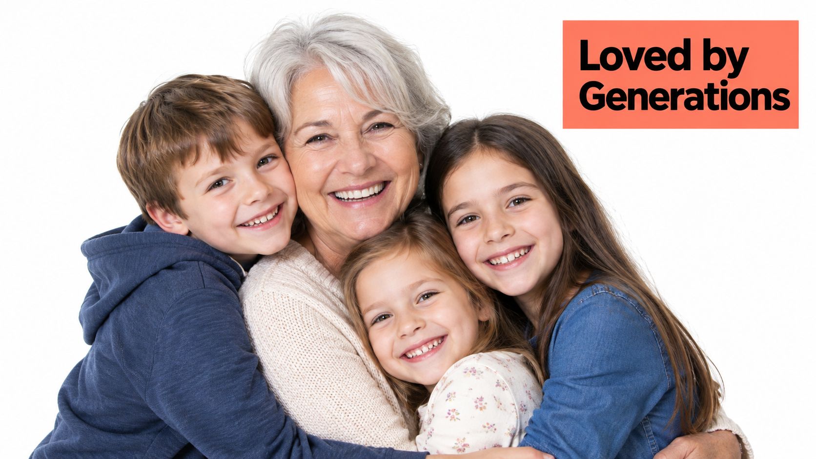 A happy grandmother smiling while being hugged by her three young grandchildren against a white background.