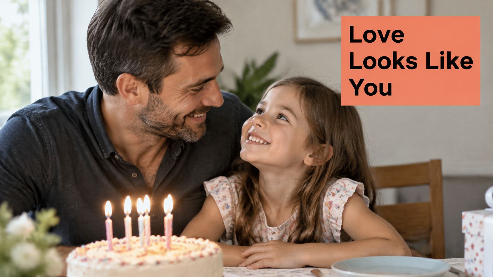 A happy father and his young daughter smiling at each other during her birthday celebration.