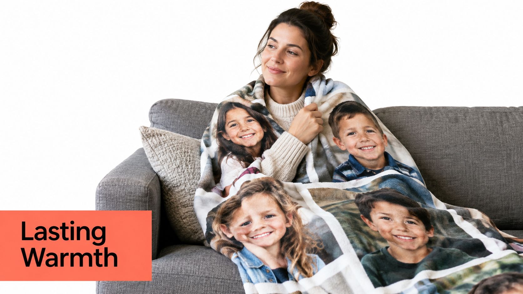 A woman sits on a grey couch wrapped in a custom photo blanket featuring portraits of four children.