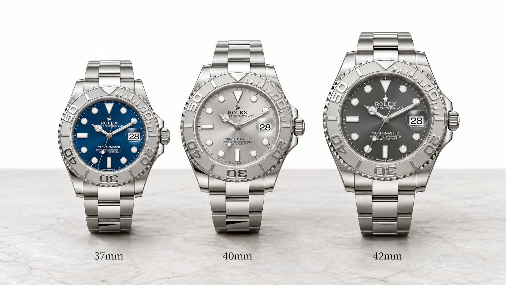 Three Rolex Yacht-Master watches in 37mm, 40mm, and 42mm sizes displayed in a row on a marble surface.