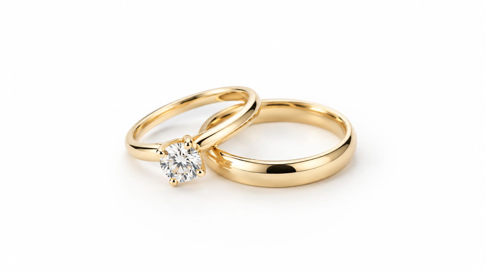 Yellow gold round diamond solitaire engagement ring next to a plain yellow gold wedding band