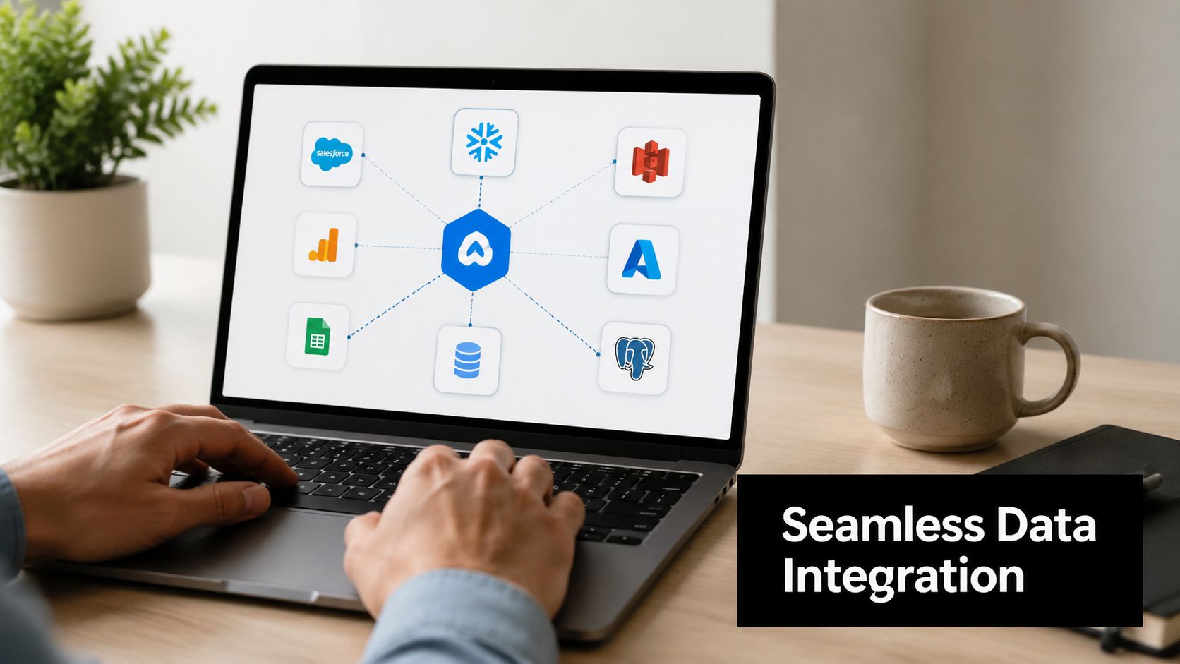 A person working on a laptop displaying a hub-and-spoke data integration diagram with various cloud service icons.