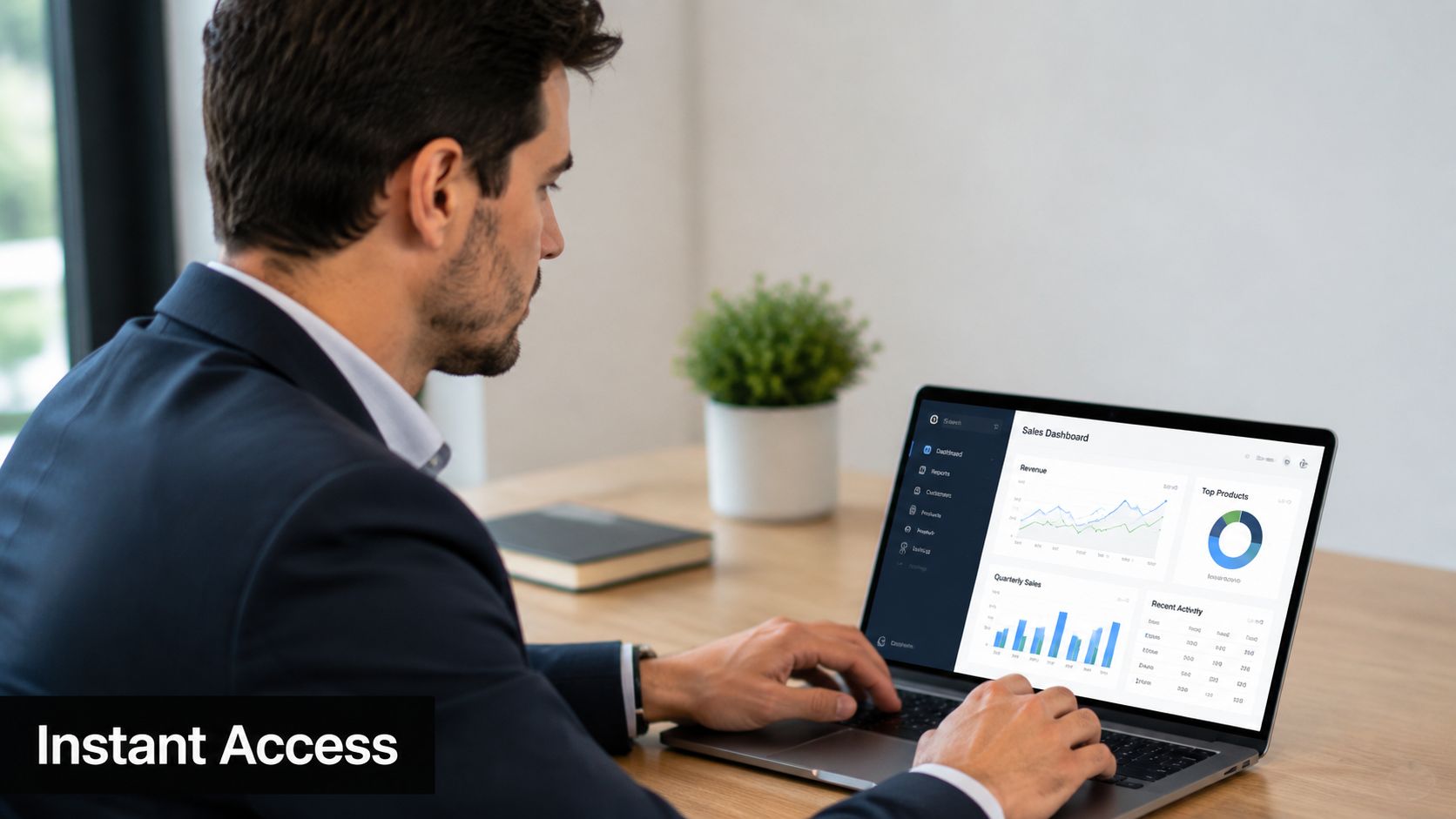 A professional man in a business suit working on a sales dashboard laptop in a modern office.
