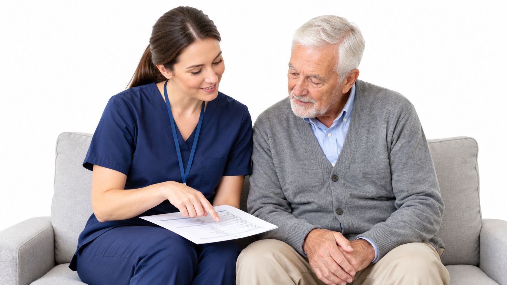 A friendly nurse explains a medical questionnaire to an elderly man sitting on a sofa.