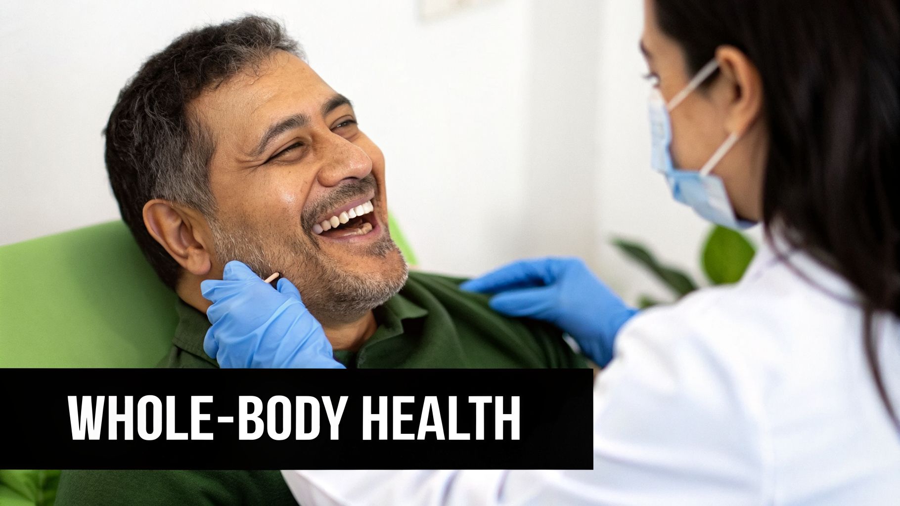 A happy man laughs while a dental professional in blue gloves examines his mouth, promoting whole-body health.