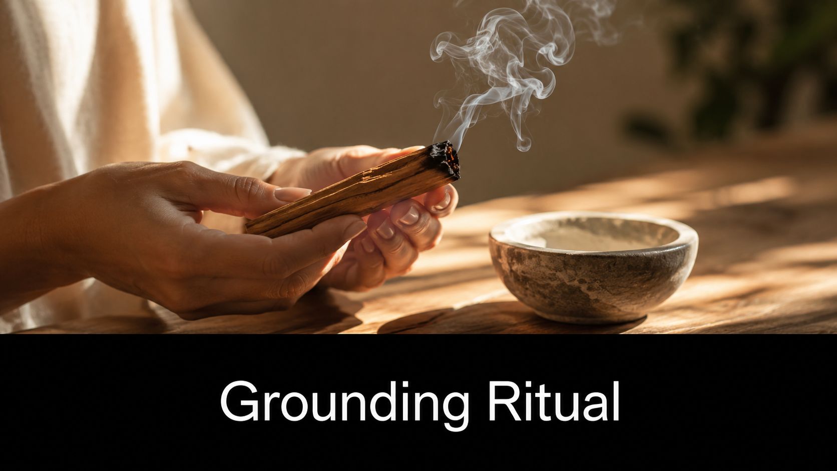 A pair of hands holding a burning piece of palo santo wood with smoke rising above a bowl.
