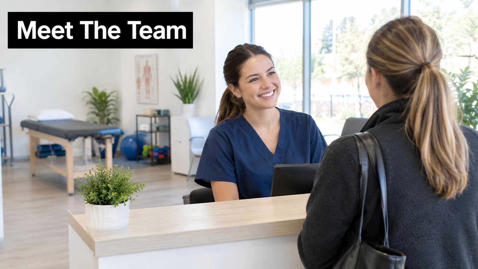 A friendly receptionist in blue scrubs greeting a patient at the front desk of a physical therapy clinic.