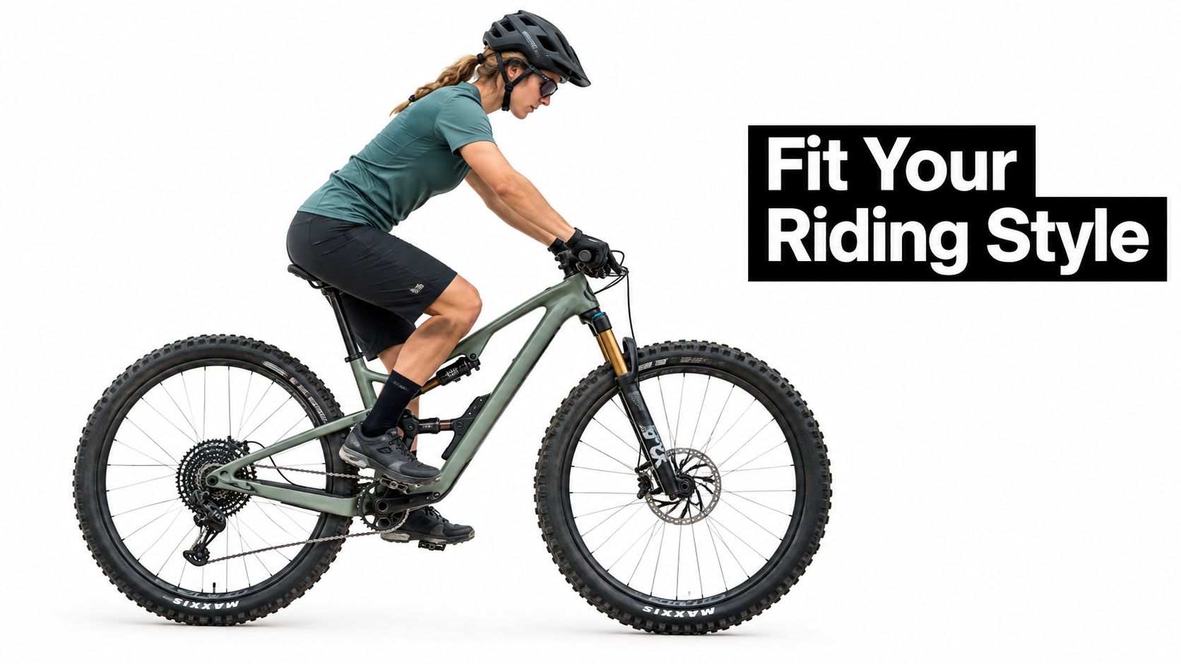 A female mountain biker riding a green full-suspension bike while wearing a helmet and cycling gear.