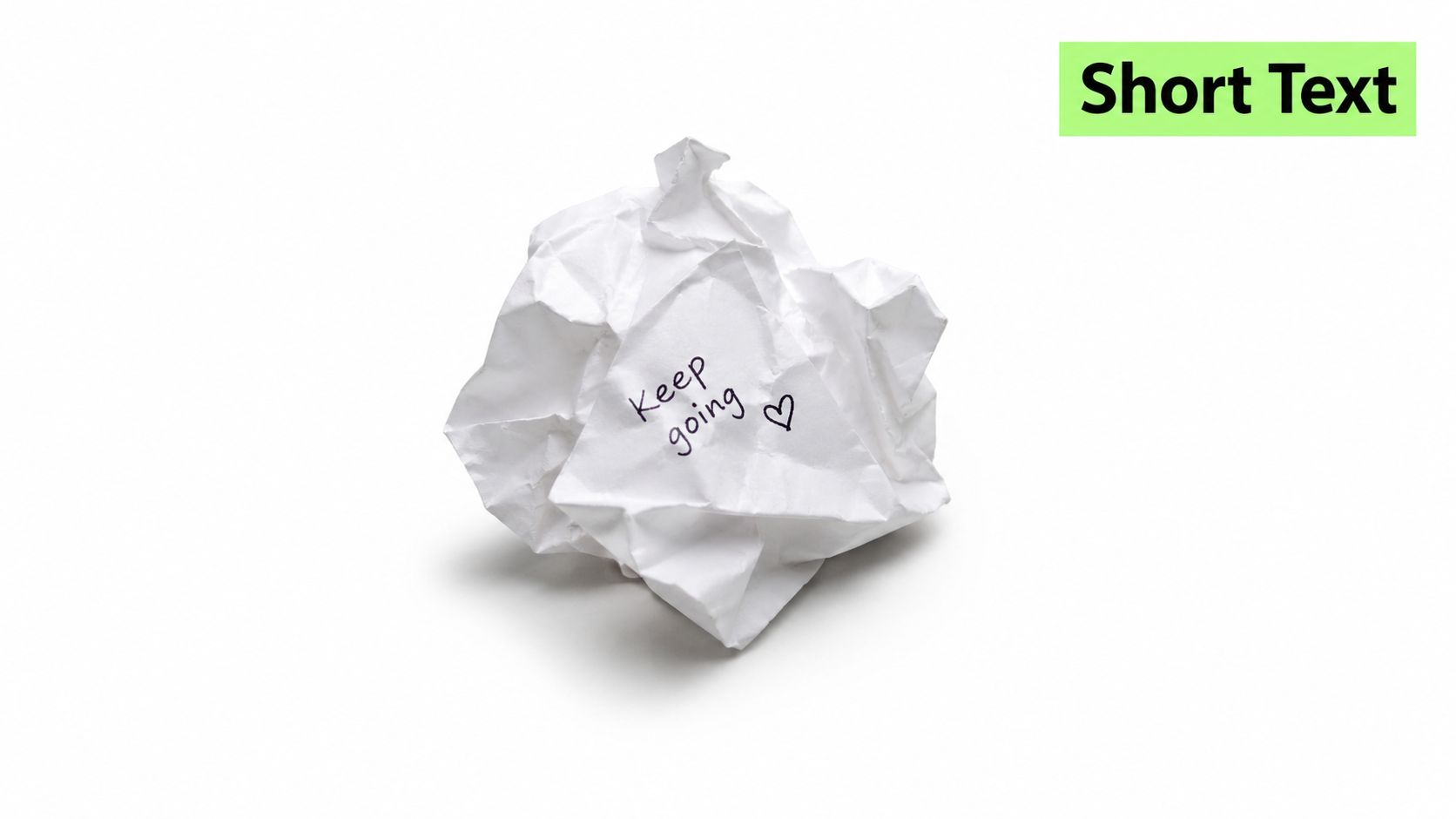 A crumpled piece of white paper with the handwritten message Keep going and a small heart icon.