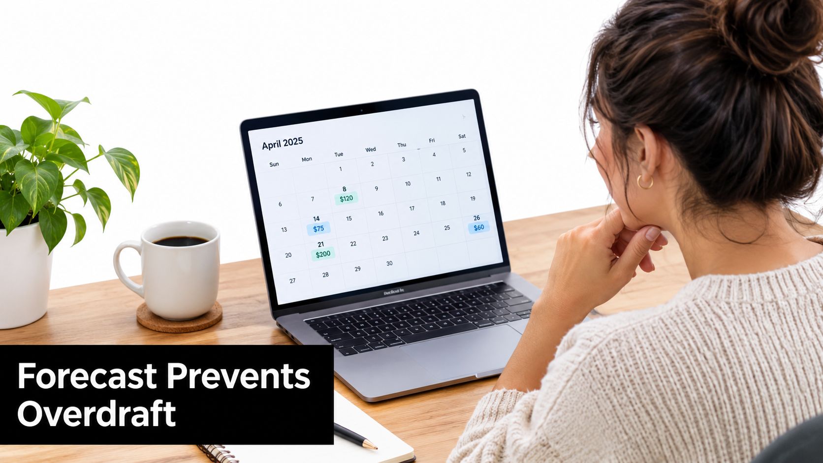 A woman reviewing her financial calendar on a laptop screen while working at her home office desk.