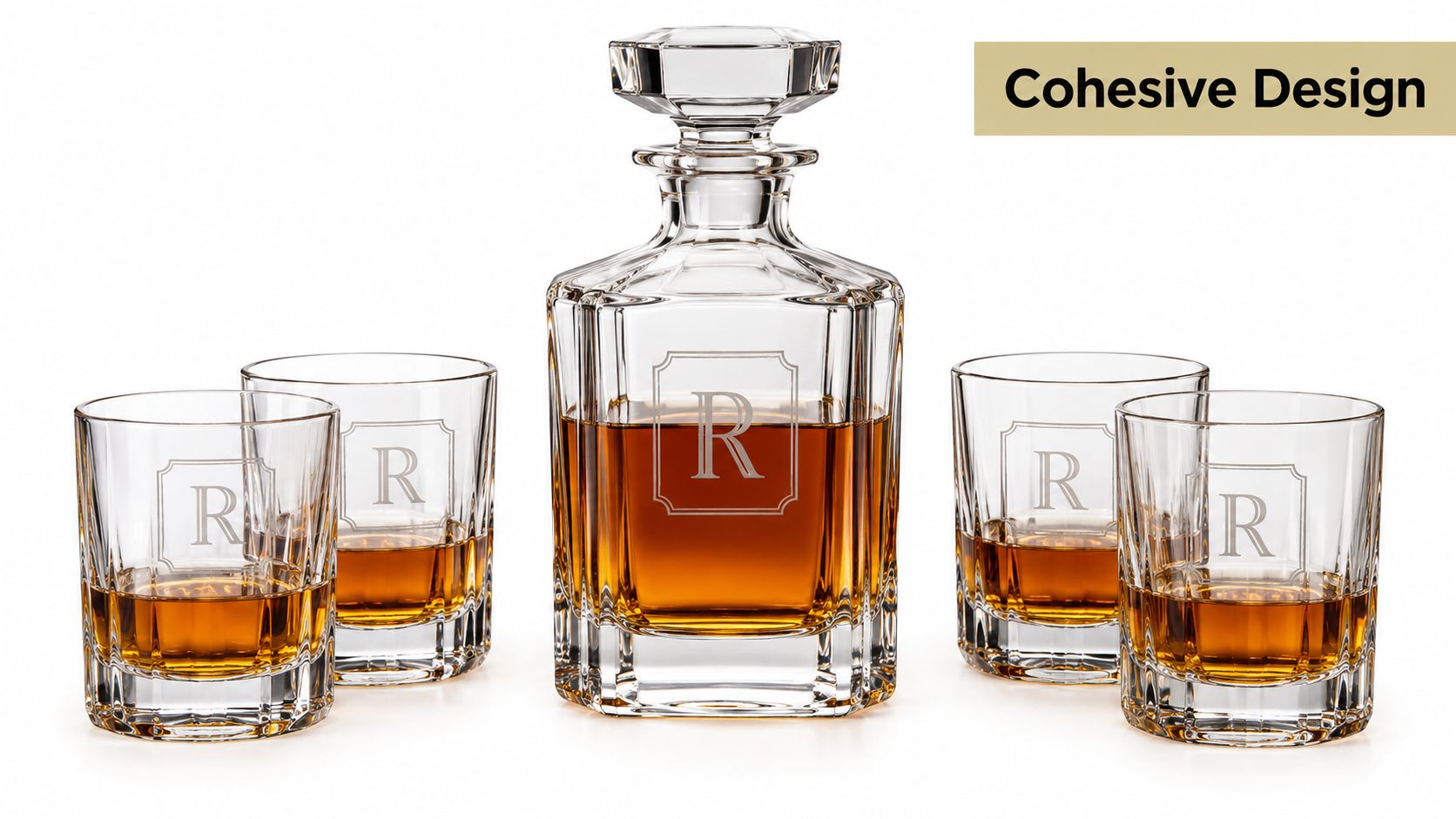 A sophisticated crystal decanter and four matching whiskey glasses each featuring a personalized letter R engraving.