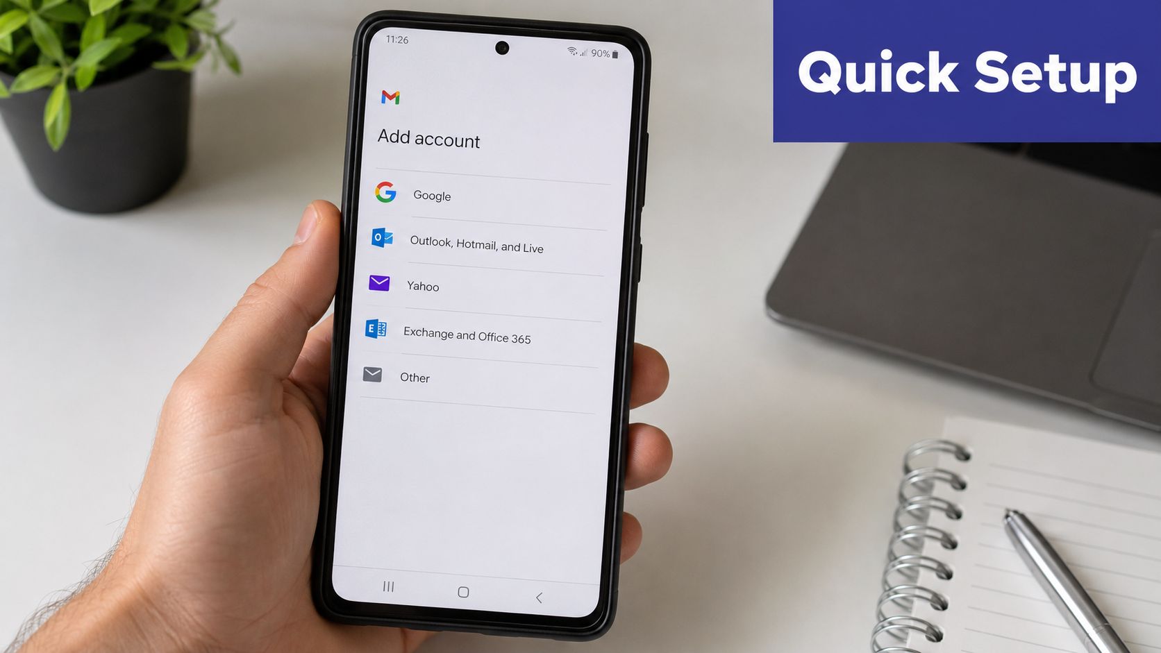 A hand holding a smartphone showing the Gmail app screen for adding new email accounts for setup.