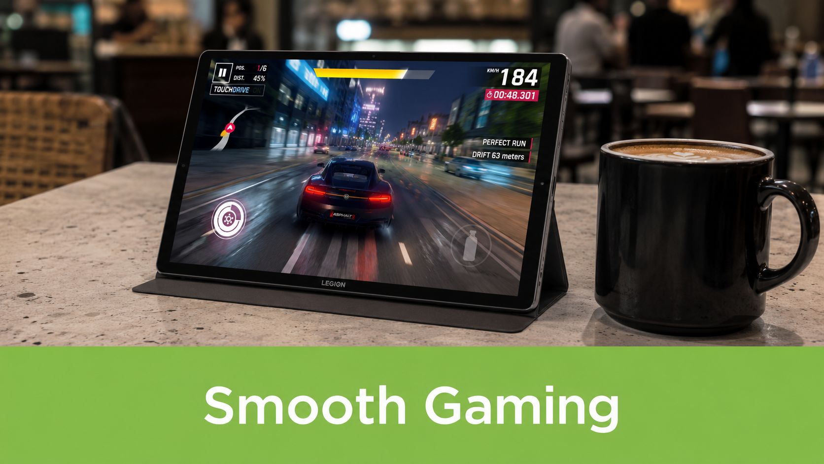 A Lenovo Legion tablet displaying a high-speed racing game beside a black coffee mug on a table.