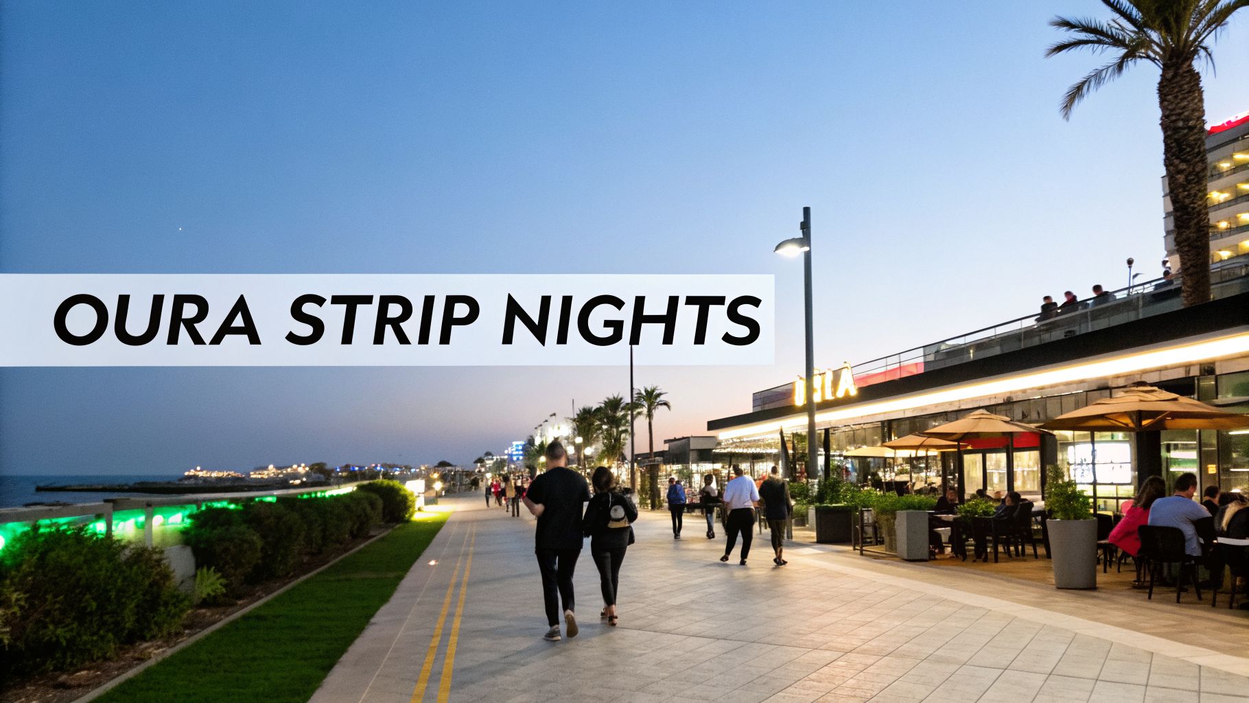 A vibrant evening scene of Oura Strip promenade with people walking, seaside restaurants, and palm trees.