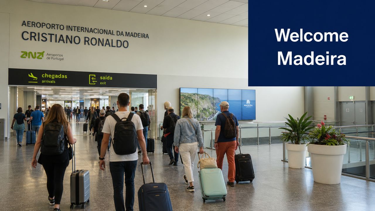 Passengers walking with luggage through the arrivals hall of Madeira International Airport Cristiano Ronaldo.