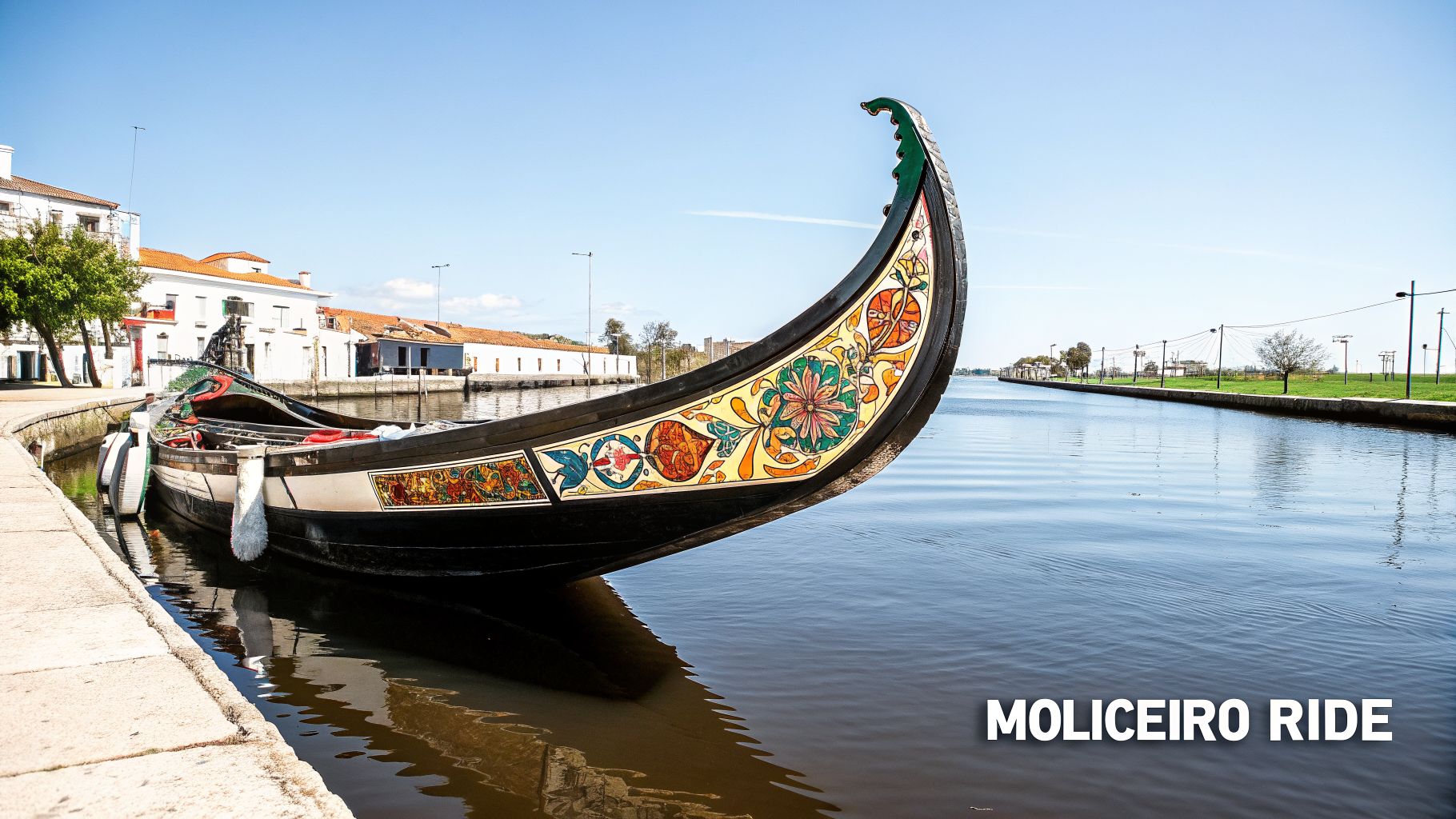 A vibrantly decorated traditional moliceiro boat docked in a tranquil canal in Aveiro, Portugal, on a sunny day.