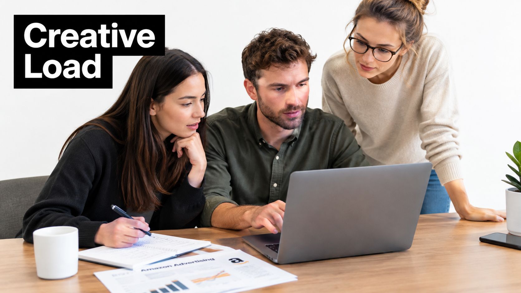 A diverse team collaborating in a bright office while analyzing Amazon advertising data on a laptop computer.