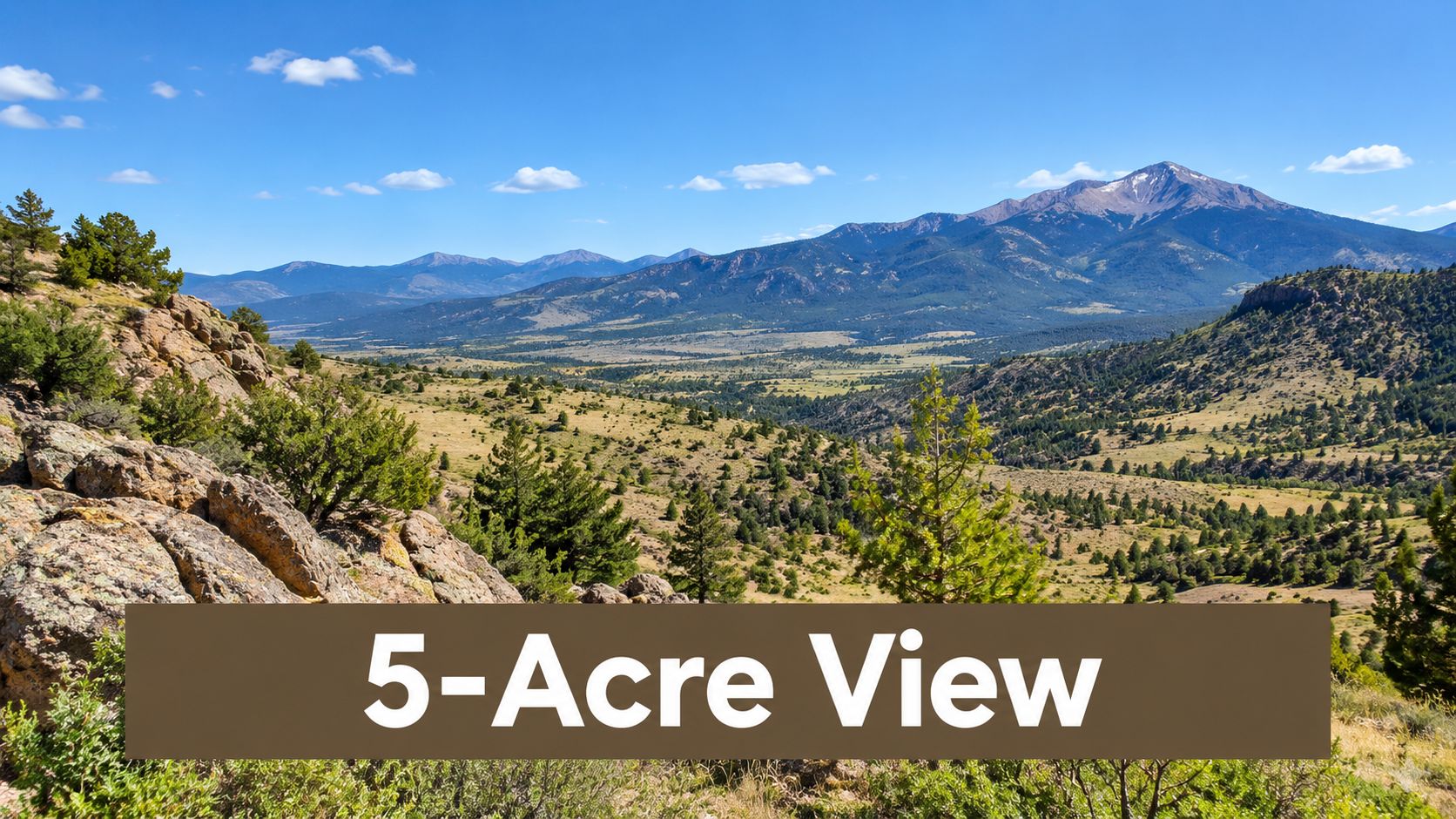 A wide, scenic view of a sunny Colorado valley and mountains under a clear blue sky.