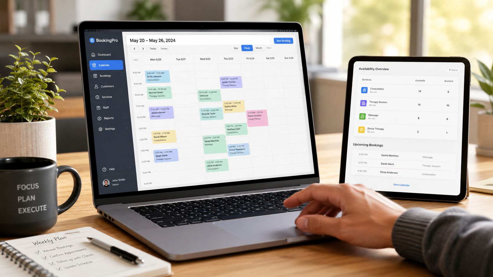 A person using a laptop and tablet to manage business appointments on a professional scheduling dashboard software interface.