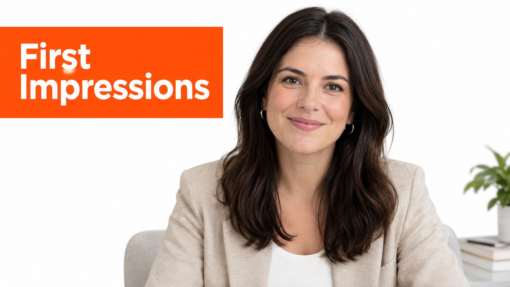 A professional woman with dark hair smiling at the camera, wearing a light blazer in an office setting.