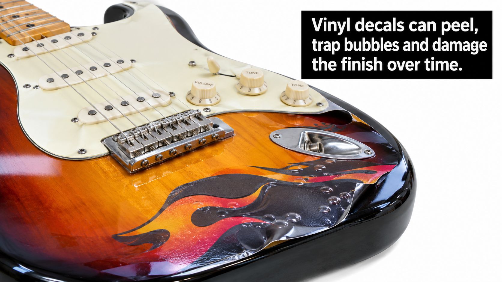 A close-up of a sunburst electric guitar body showing a damaged, bubbling flame-pattern vinyl decal applied to it.