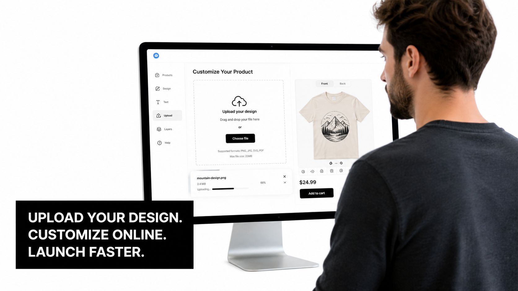 A man using a computer to design and upload a graphic for custom shirts online.