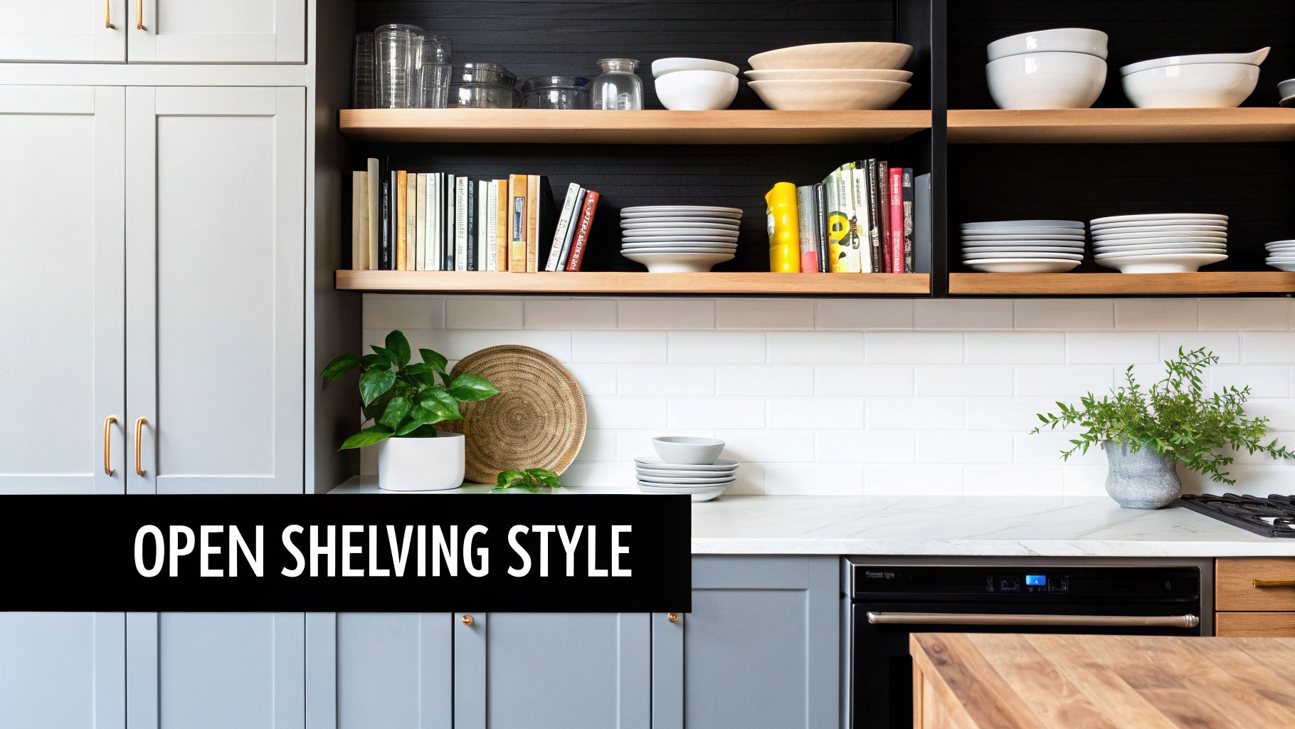 A modern kitchen with gray cabinets, white subway tile backsplash, and wooden open shelving styled with dishes and books.