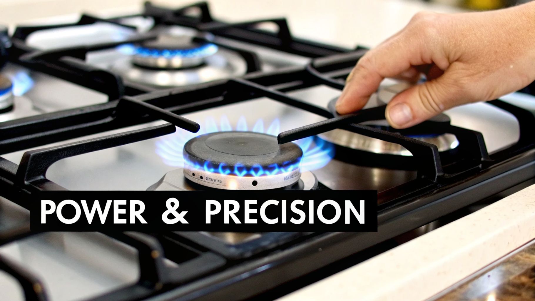 A close-up of a hand turning a knob on a sleek gas stove, with blue flames burning, showing power and precision.