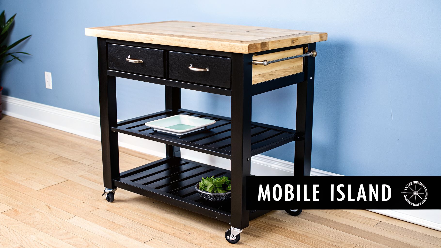 A black mobile kitchen island cart with a light wood top, drawers, and shelves on wheels.