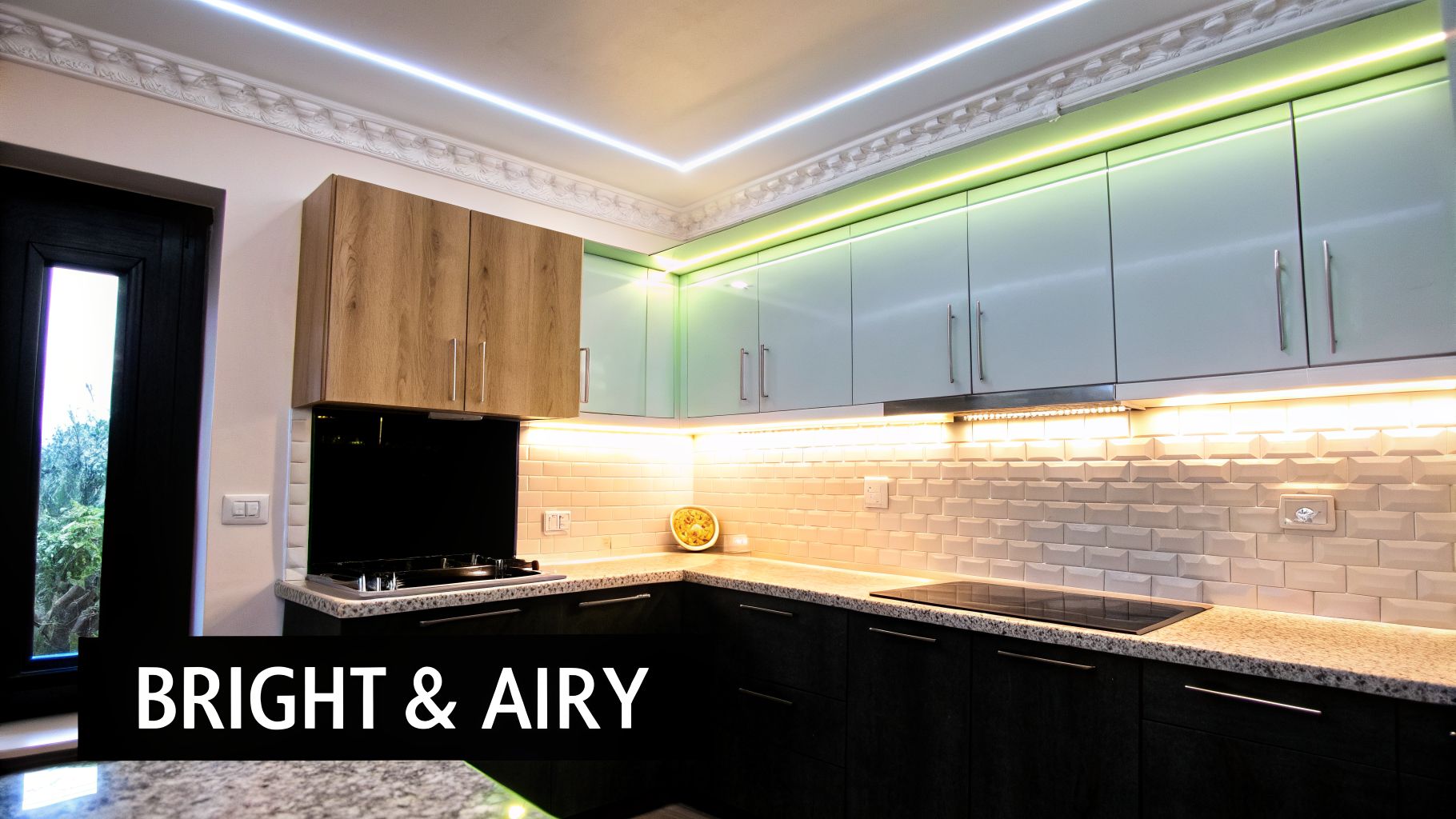 Modern kitchen interior featuring sleek cabinets, strip lighting, and a subway tile backsplash for a bright look.