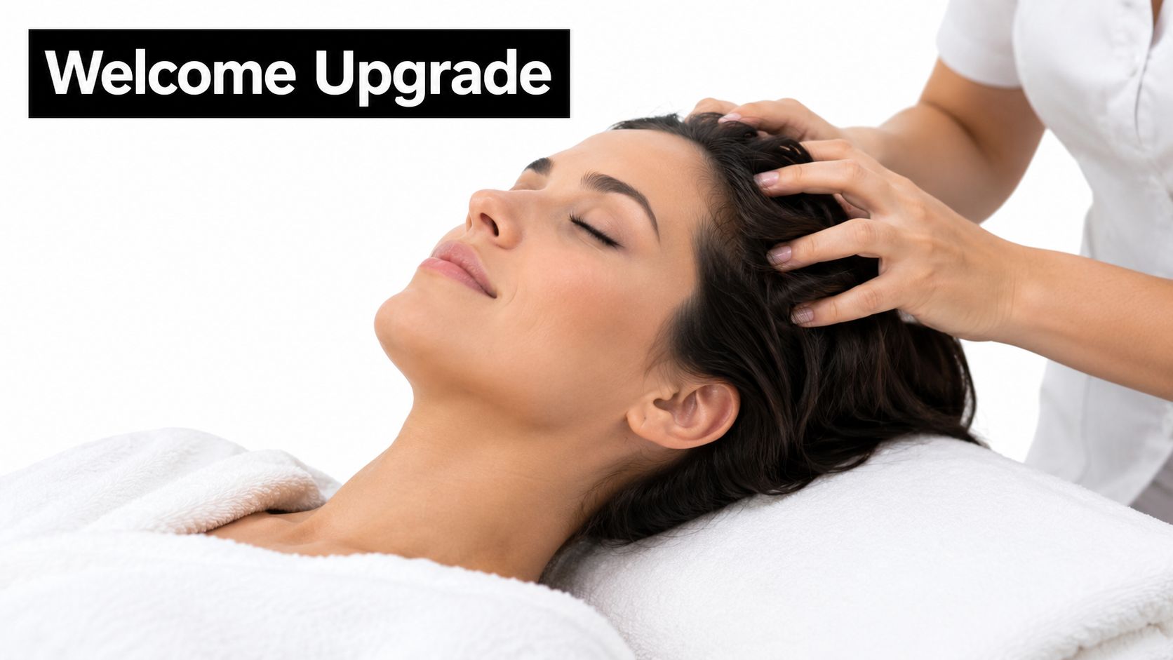 A professional massage therapist provides a relaxing scalp massage to a woman lying on a spa bed.