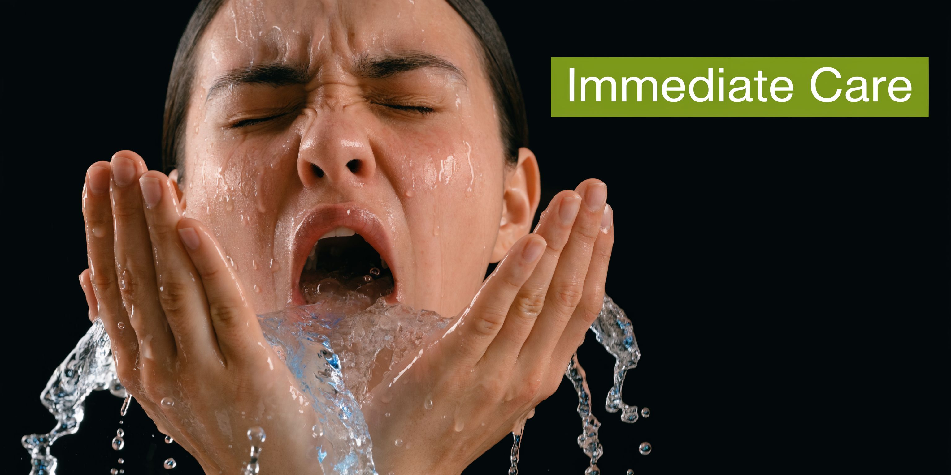 A distressed person rinsing their mouth with water against a black background to signify emergency dental care.