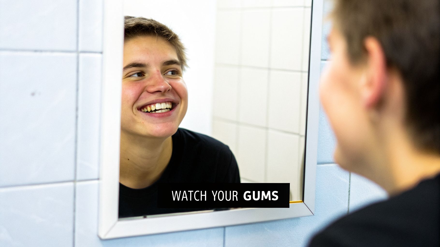 A smiling young person checks their teeth and gums in a bathroom mirror, with the text 'WATCH YOUR GUMS'.