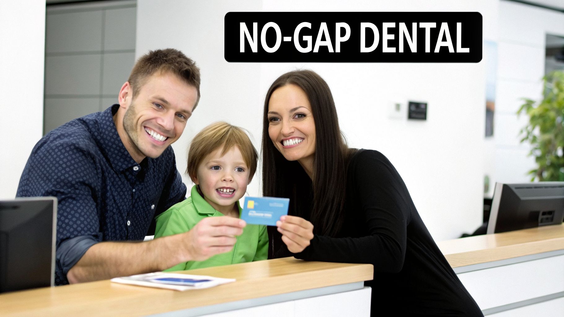 A smiling family, including a man, woman, and child, holding a blue health card at a dental reception.