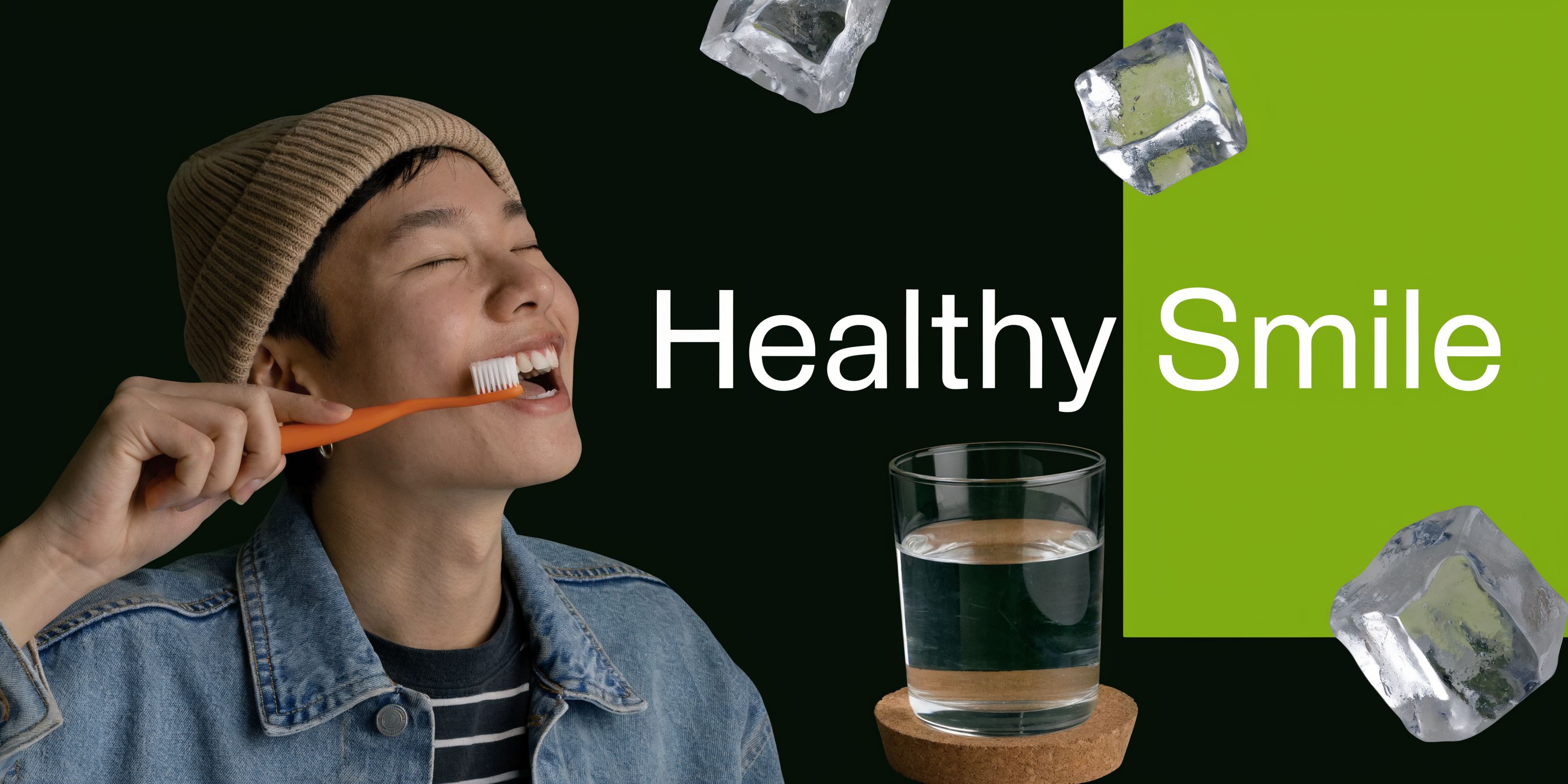 A person wearing a beanie and denim jacket brushing their teeth with an orange toothbrush near ice cubes.