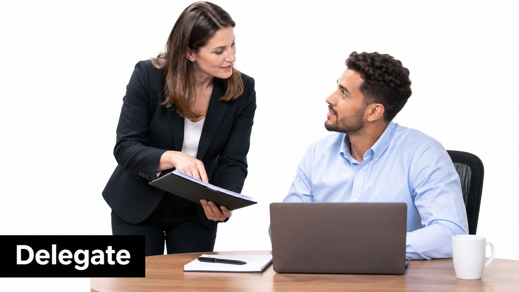 A professional woman in a suit pointing to a document while consulting with a male colleague.