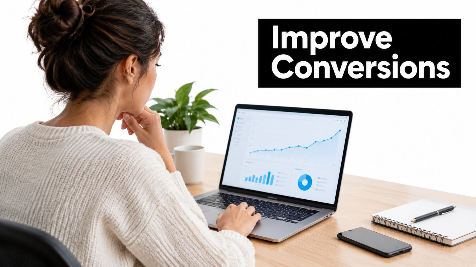 A woman working on a laptop displaying business analytics data to help improve website conversion rates.