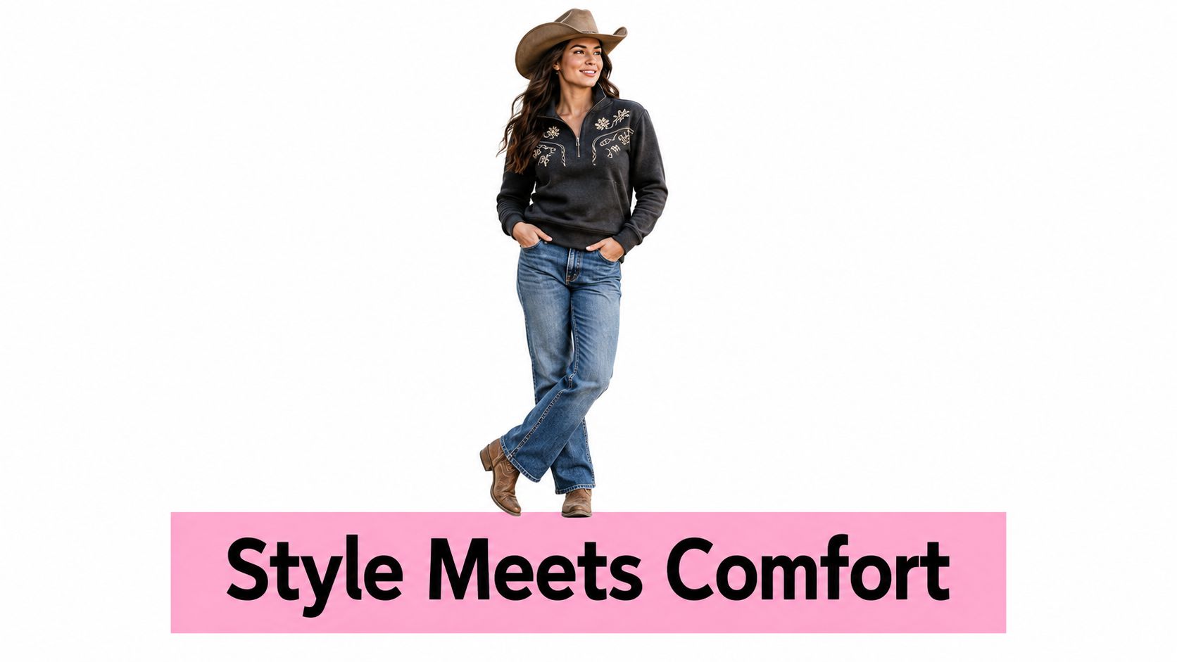 A woman wearing a western cowboy hat, an embroidered charcoal pullover, and blue jeans standing comfortably.