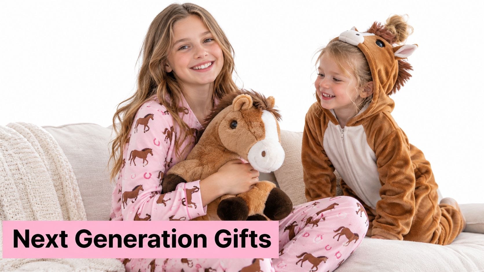 Two happy girls wearing horse-themed pajamas and a horse onesie playing with a plush toy horse.