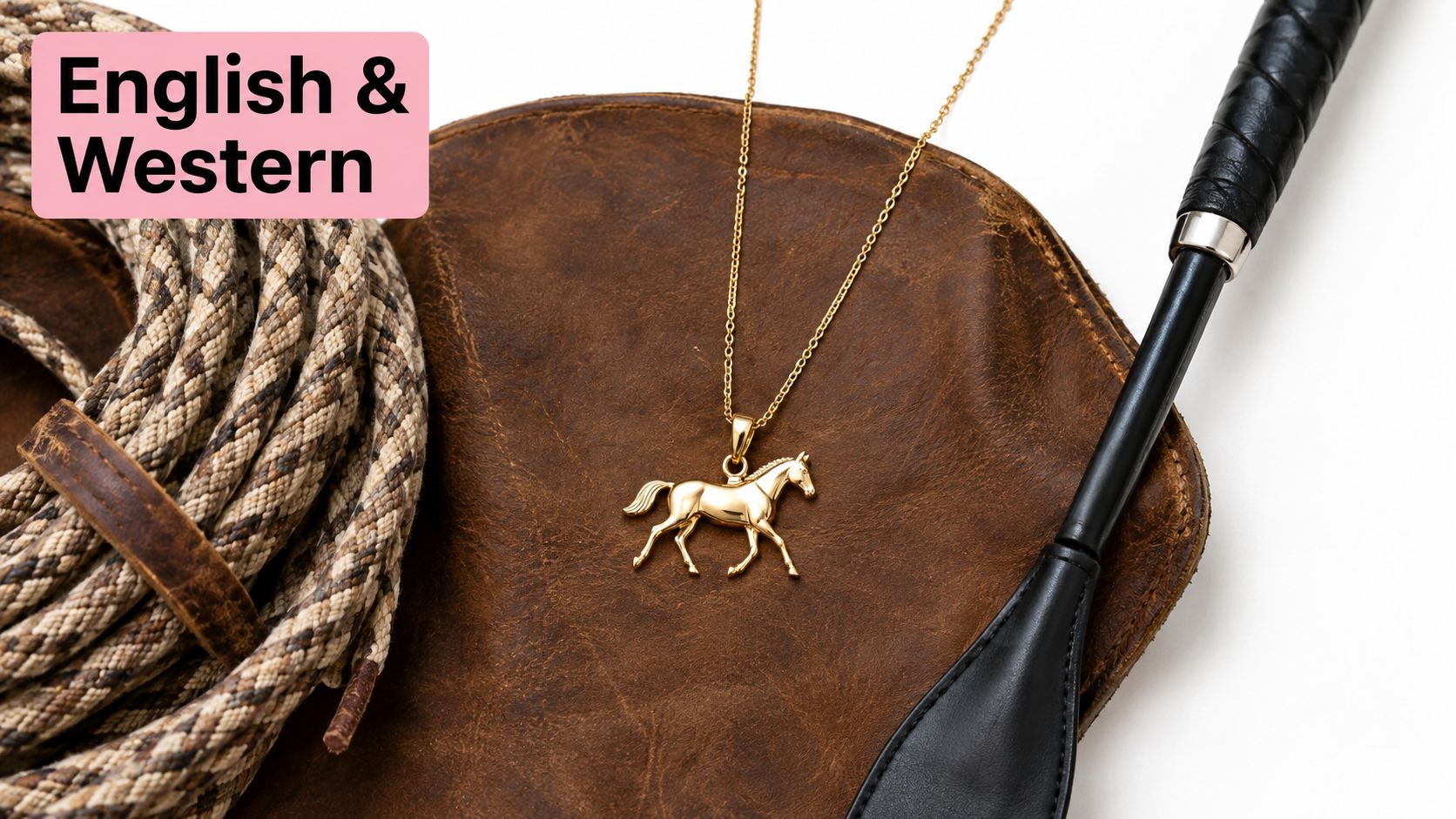 A gold horse pendant necklace resting on brown leather with a coiled rope and riding crop.