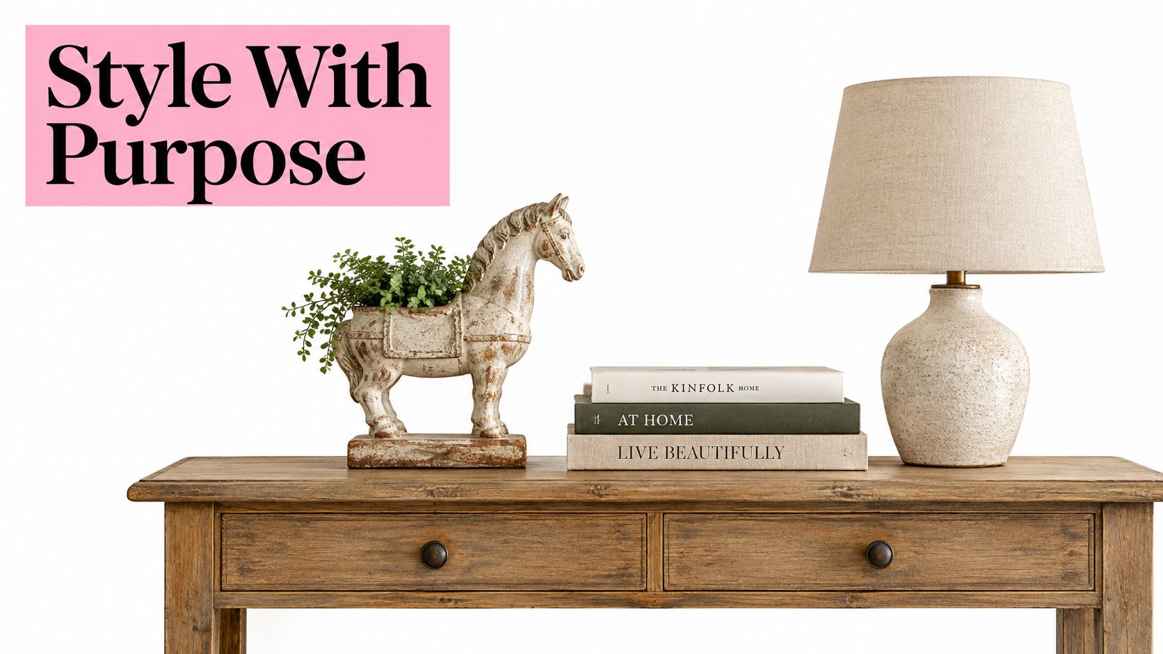 A rustic horse planter next to stacked books and a table lamp on a wooden console table.