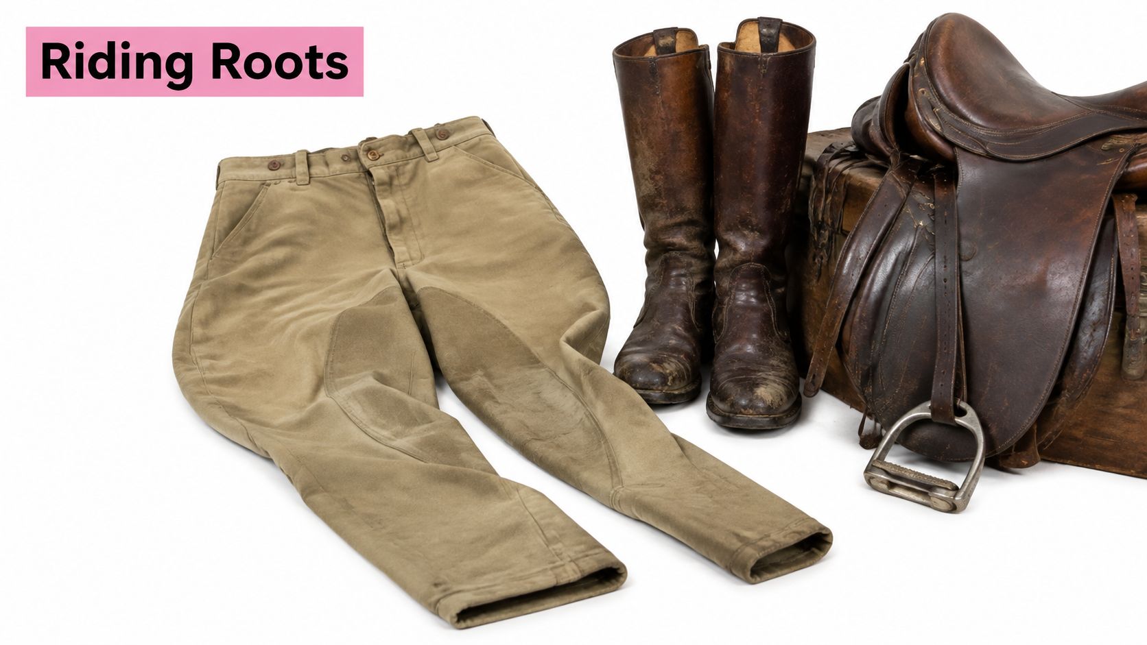 A pair of vintage khaki riding breeches next to tall leather riding boots and a leather saddle.