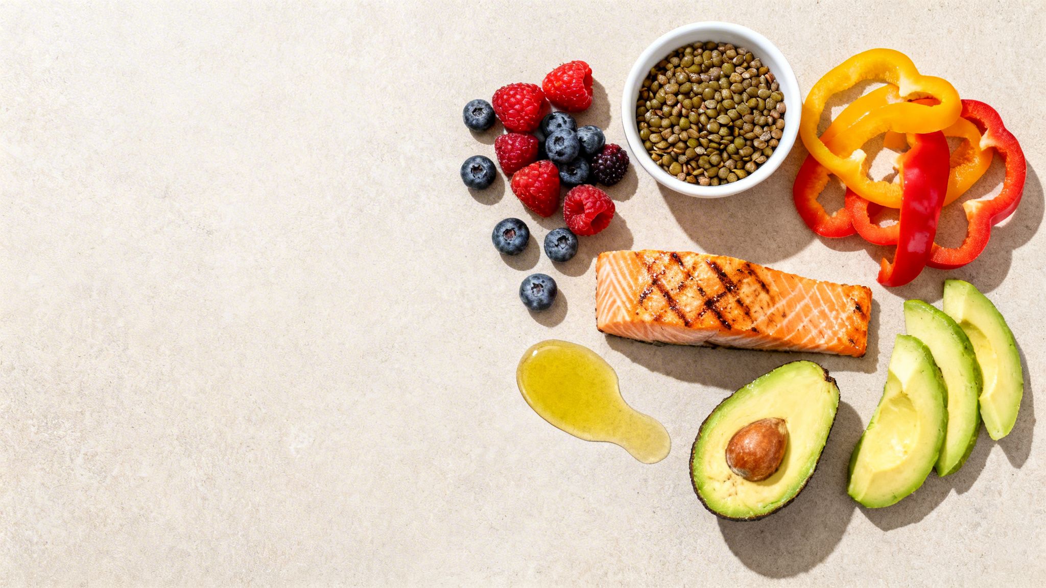 Healthy diet ingredients: grilled salmon, avocado, mixed berries, lentils, bell peppers, and olive oil.