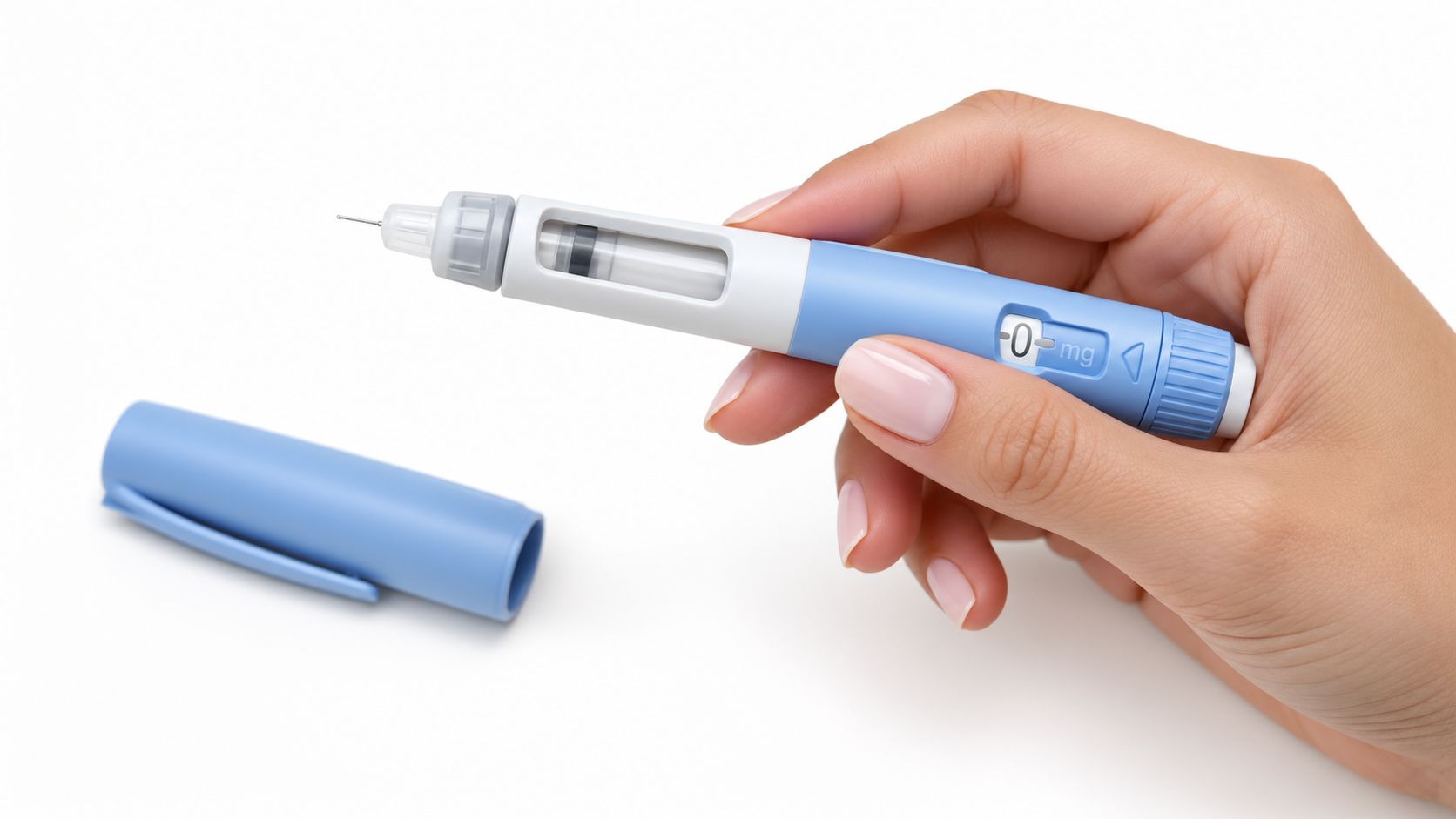 A hand holding a blue GLP-1 weight loss pen with an attached needle and detached cap.