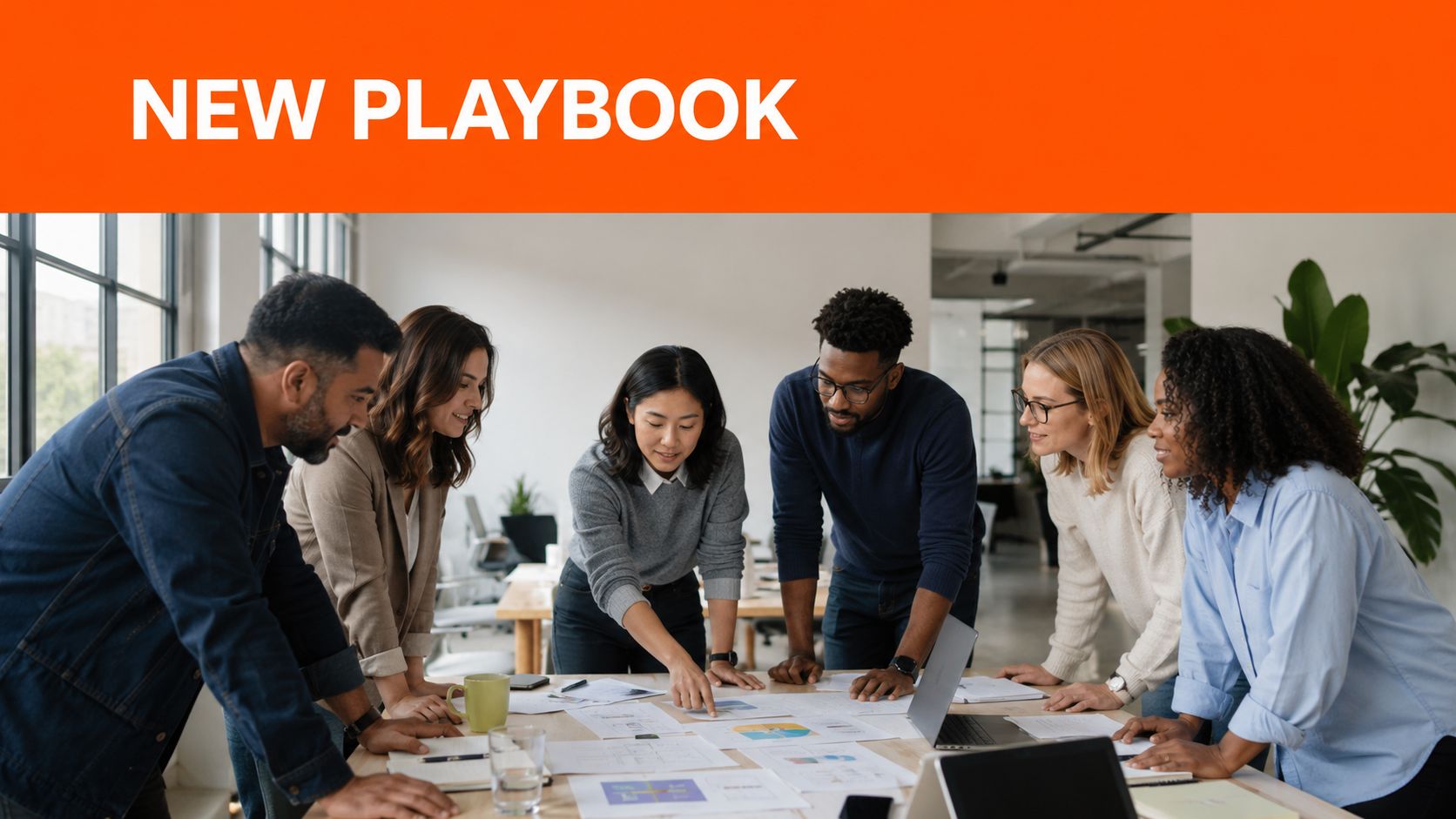 A diverse group of professional colleagues collaborating around a table during a team meeting in an office.