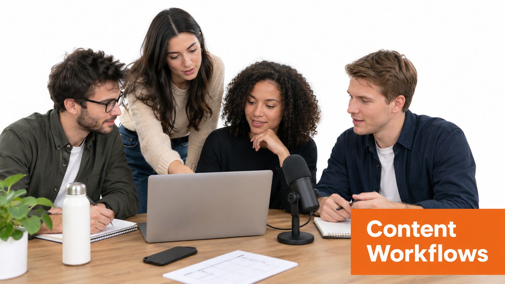 A diverse team of four colleagues collaborating on a content workflow project using a laptop and microphone.