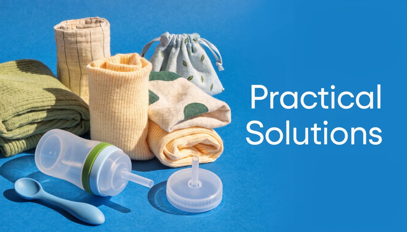 A collection of baby essentials including rolled clothing, a small patterned pouch, baby bottle, and a spoon.