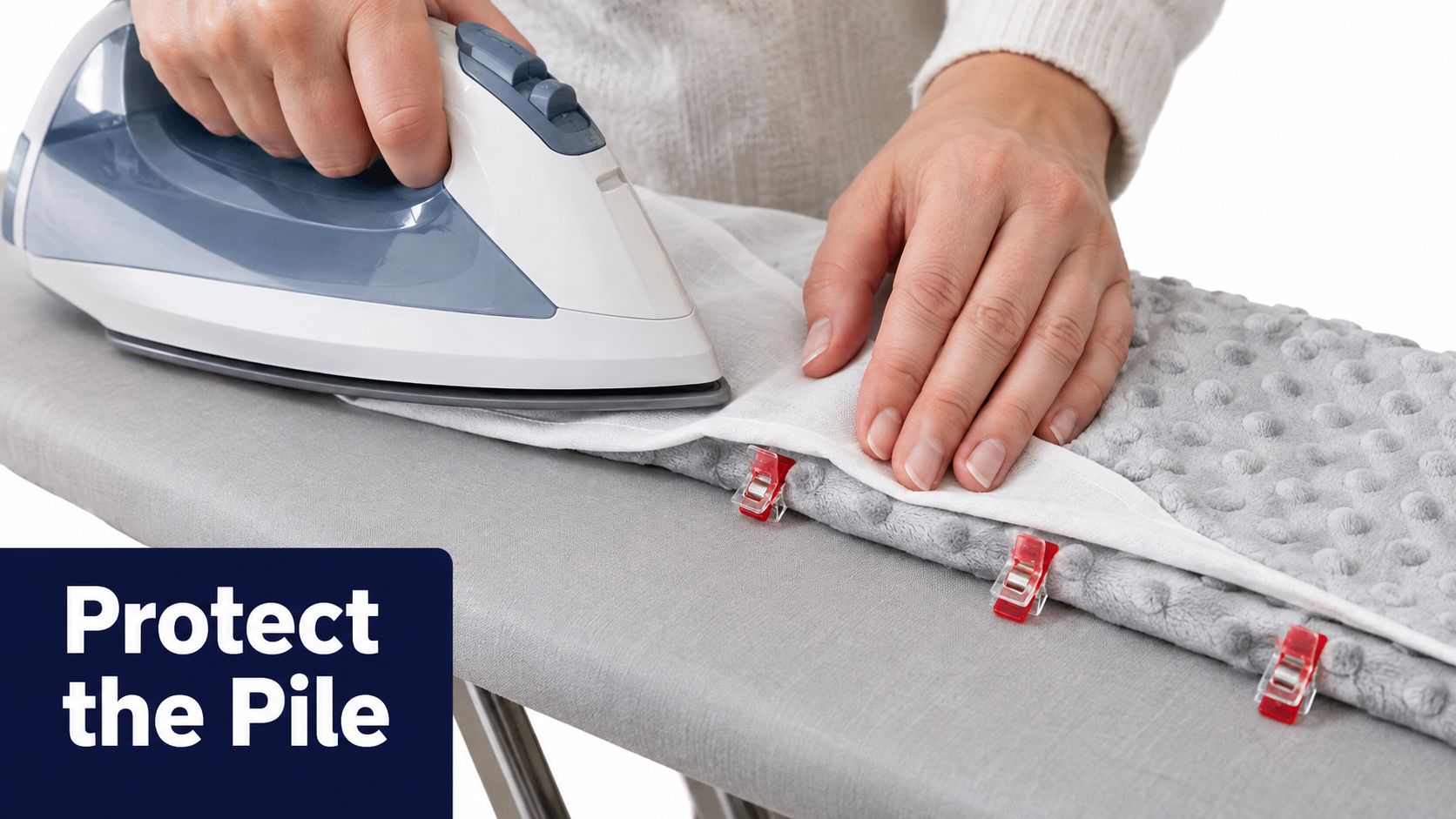 A person ironing a delicate minky fabric project using a pressing cloth to protect the textured pile.