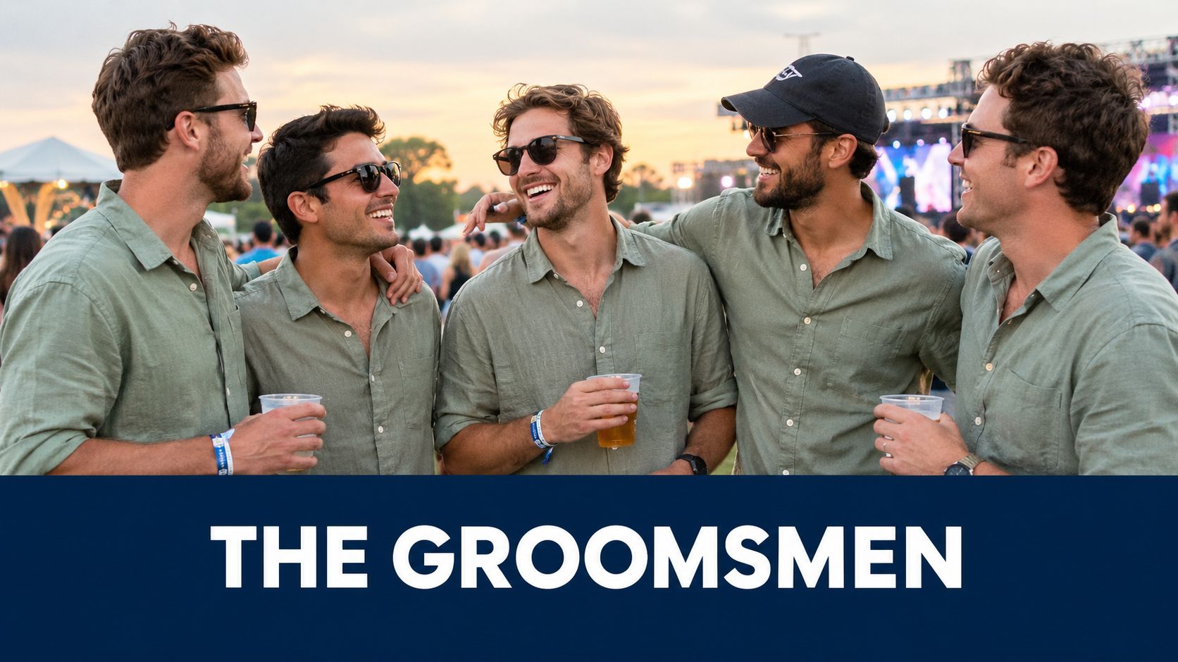 A group of five men wearing matching sage green linen shirts smiling and laughing at a music festival.