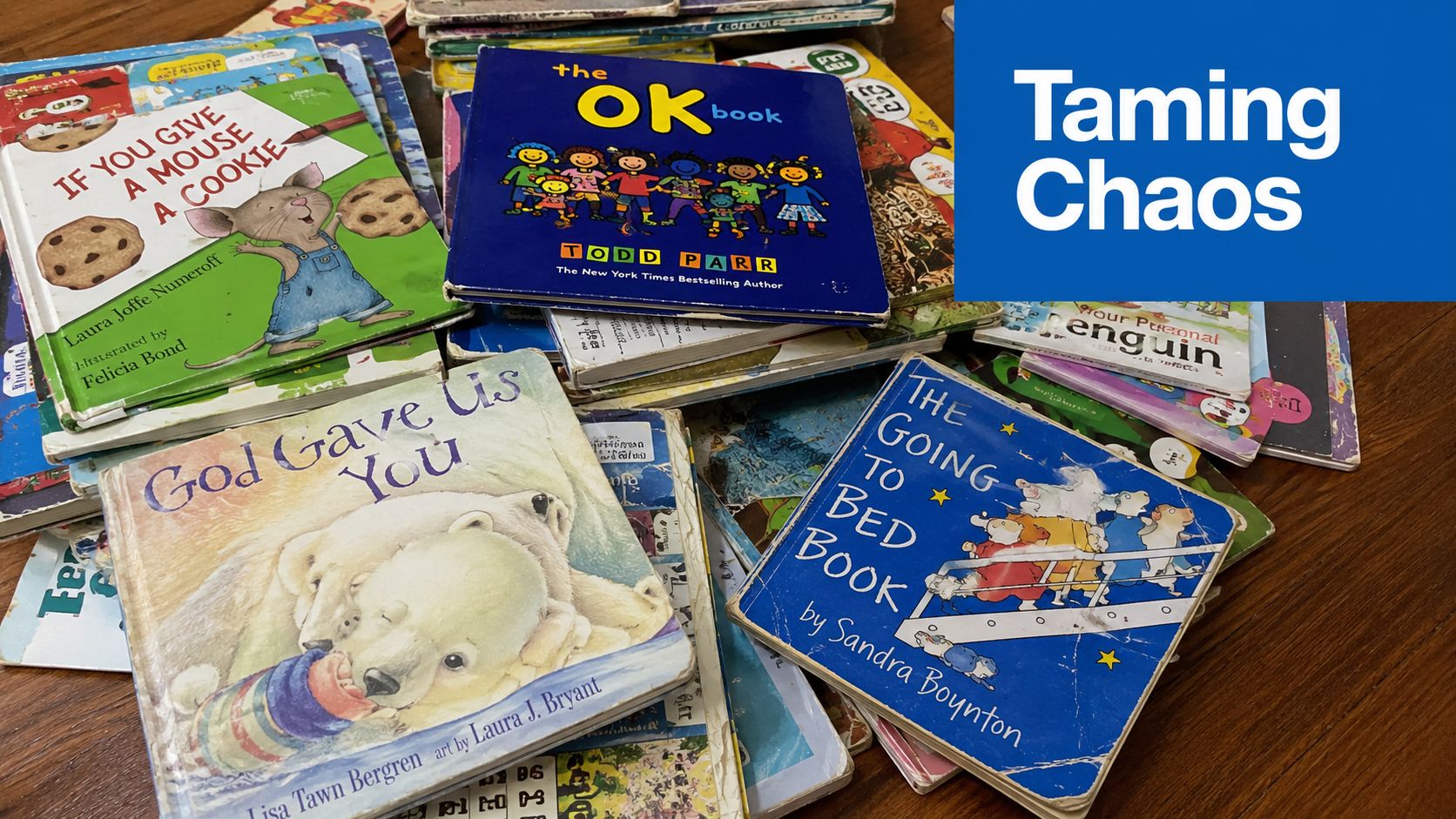 A chaotic stack of children's books by various authors on a wooden surface with a blue overlay.